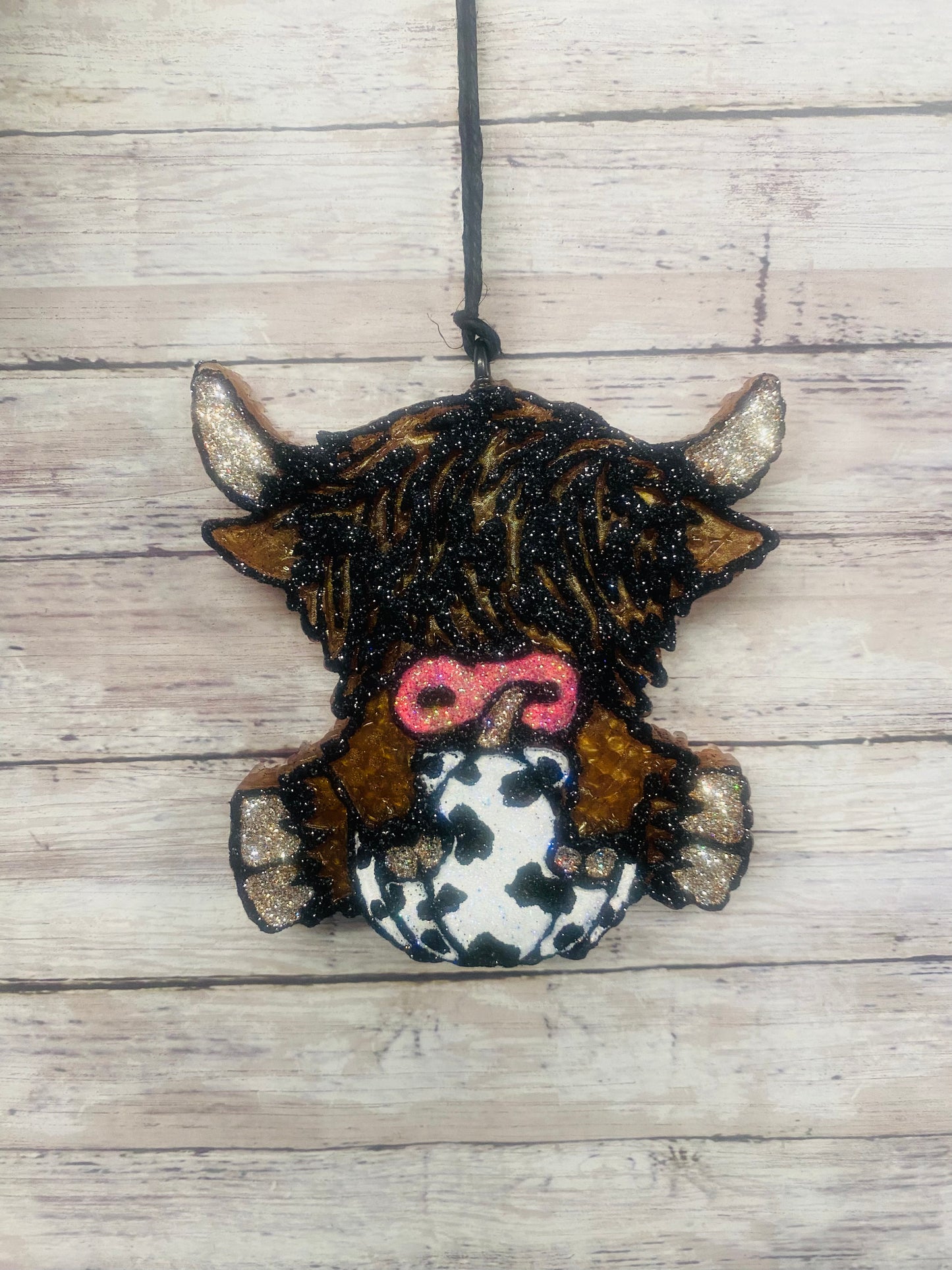 Highland Cow Holding A Pumpkin